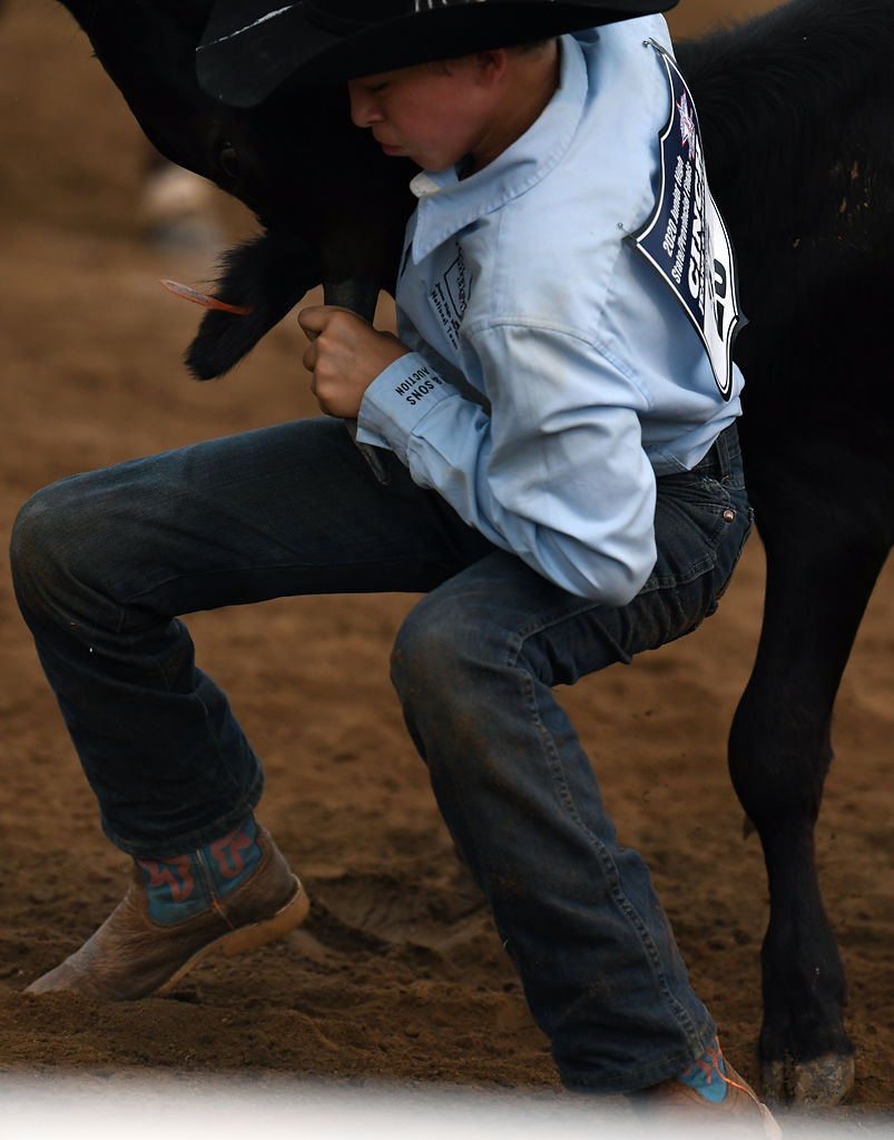 Will Coleman of Marshall attempts to wrestle a steer to the ground on Saturday